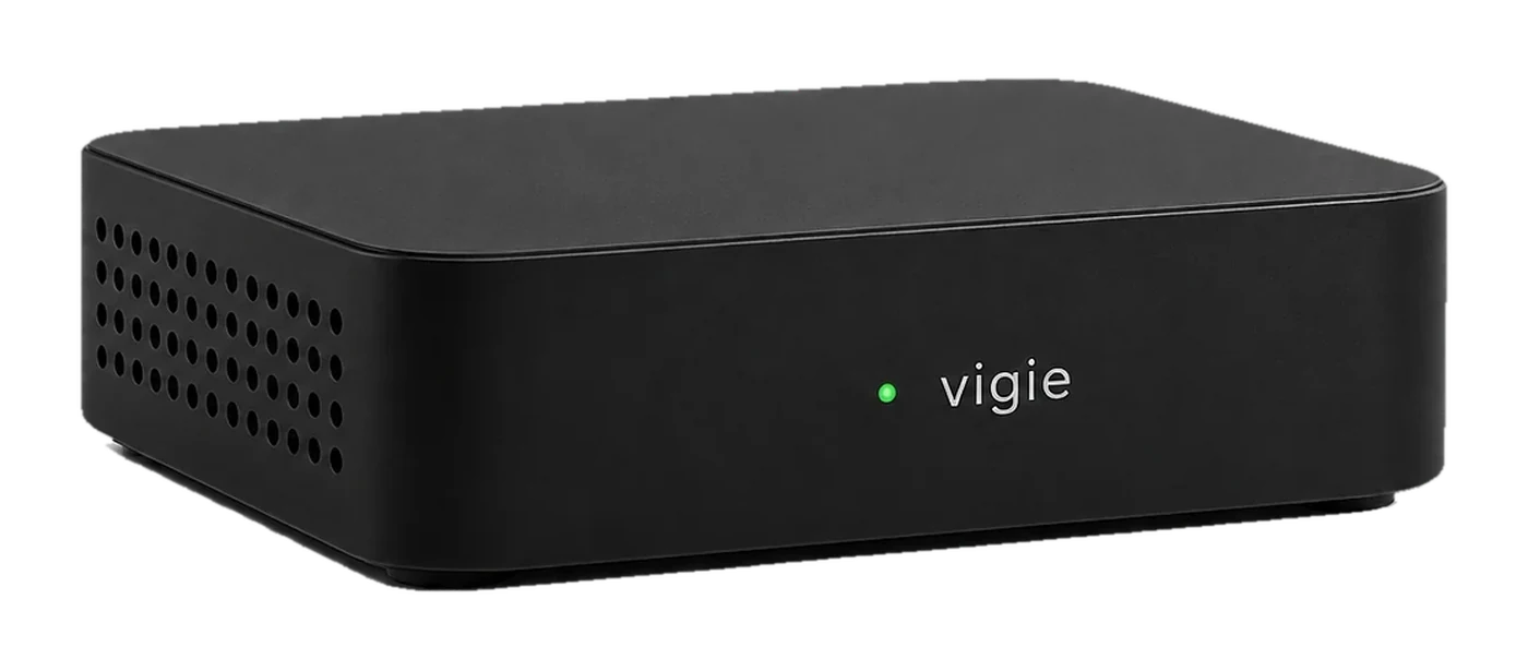 La box vigie, un petit boîtier noir mat avec une LED verte allumée.